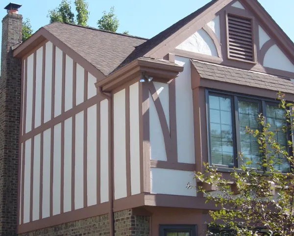 An after image of a two-story home that's just been painted white.