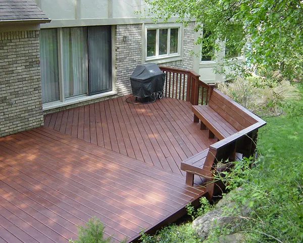 An after image of a deck that has been stained with an opaque red-colored stain